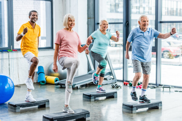 Seniors doing aerobic exercise class at gym