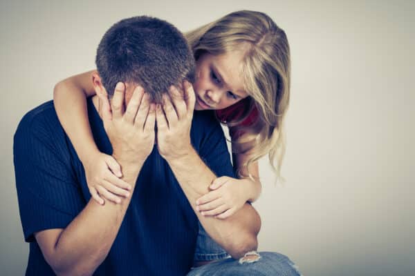 Daughter comforts her depressed father