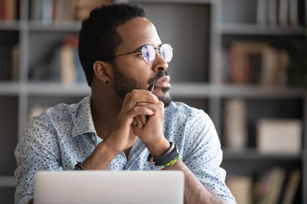 Man daydreaming or thinking while doing work