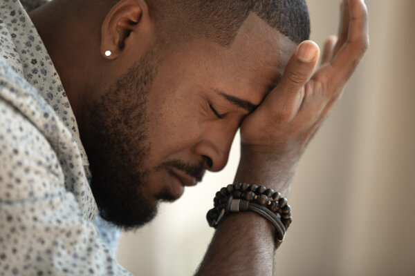 Man crying alone, battling depression or grief