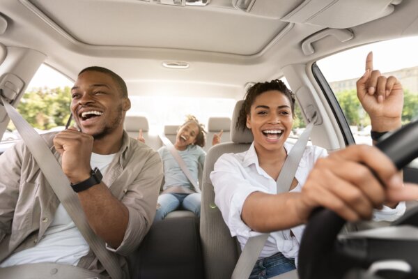 Family dancing and singing in the car
