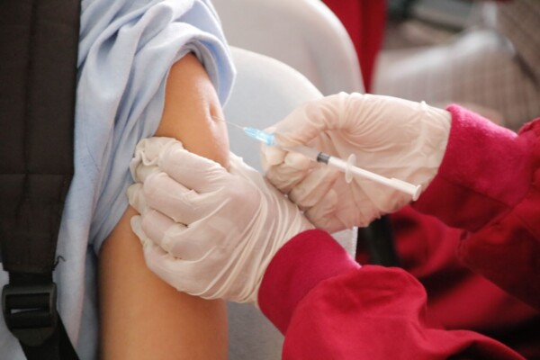 Healthcare professional giving patient a vaccine