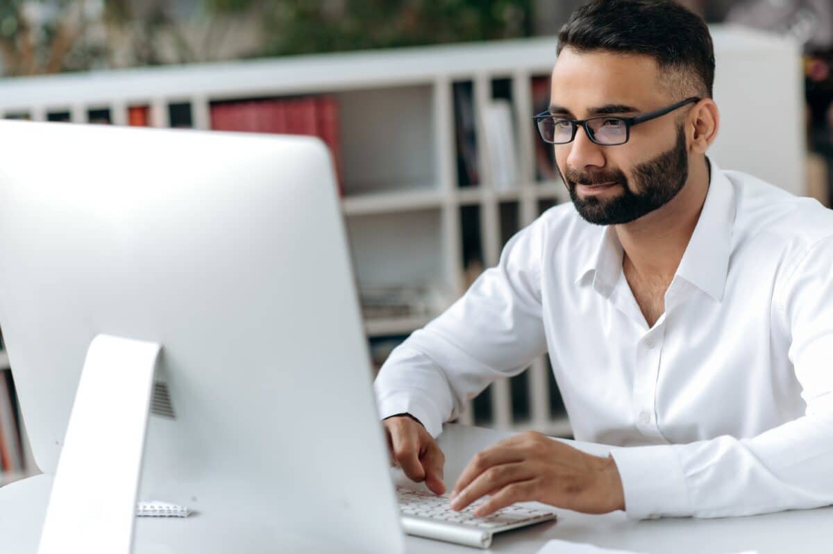 Business man doing work at his desktop computer