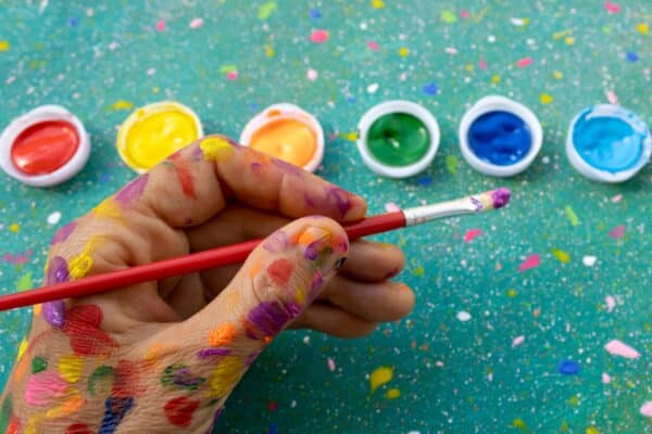 Artist painting with their left hand