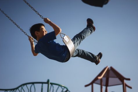 Child playing on swing set