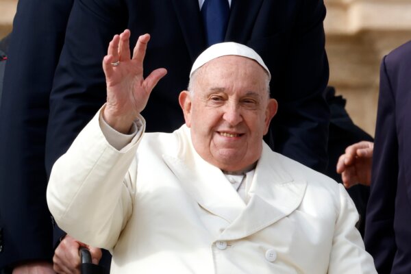 Pope Francis waves to the faithful at the end of his weekly general audience in St. Peter's Square at the Vatican