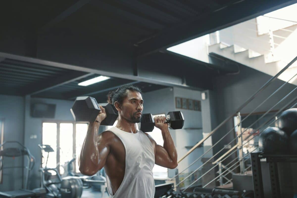 Man doing shoulder presses at the gym