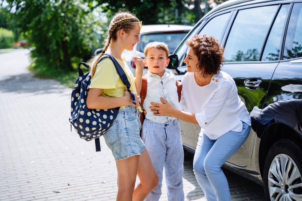 Single mom dropping kids off at school