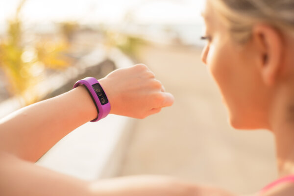 Woman out walking checks her daily steps on her smartwatch